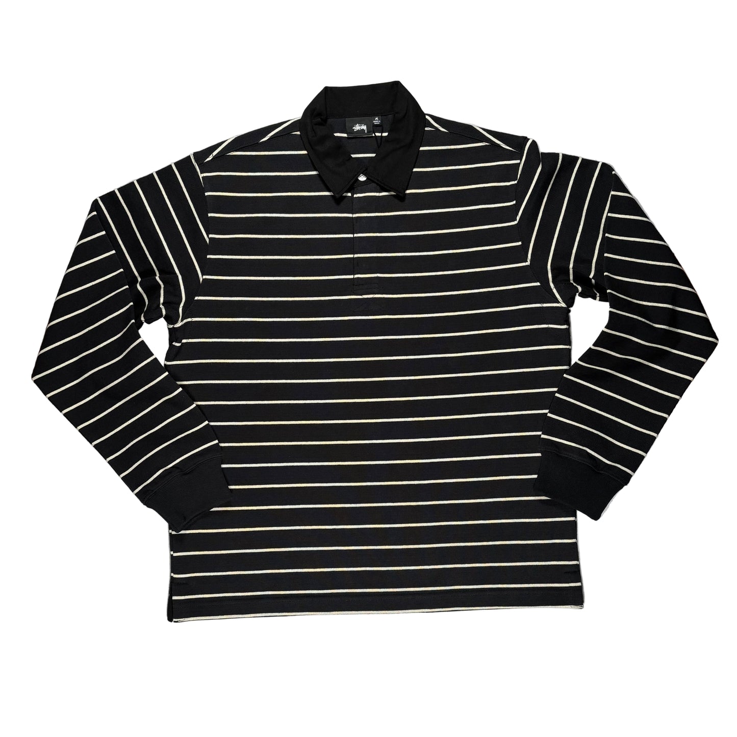 Black and white striped long-sleeve shirt on a white surface 