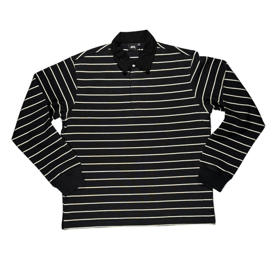 Black and white striped long-sleeve shirt on a white surface 