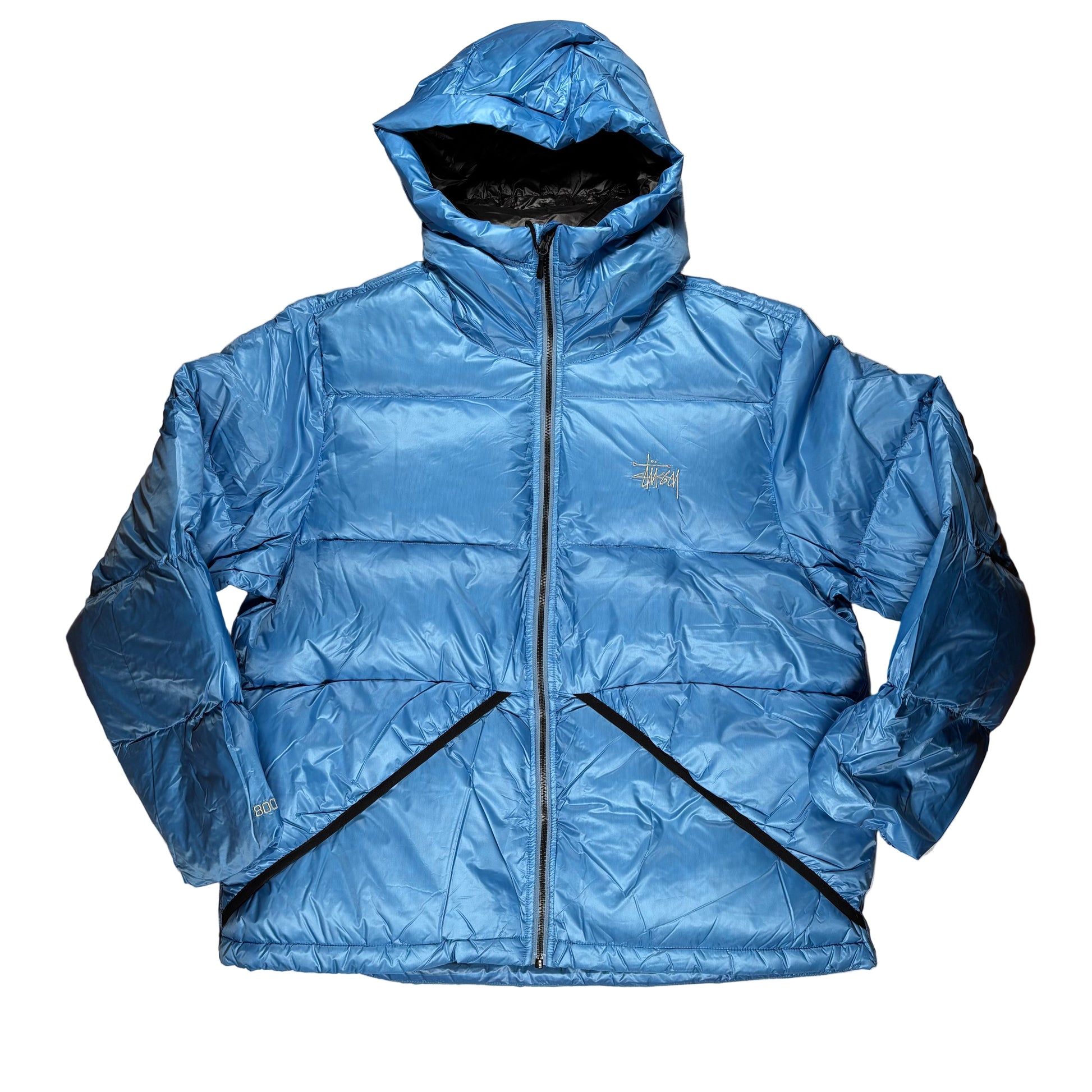 Blue puffer jacket on a white surface