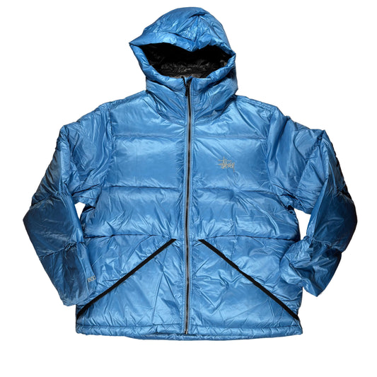 Blue puffer jacket on a white surface