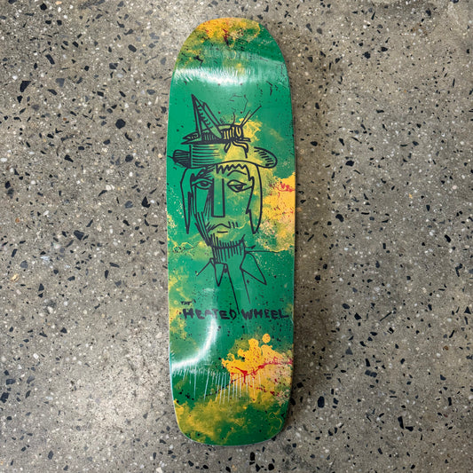 abstract mand face, on multi green/yellow skate deck