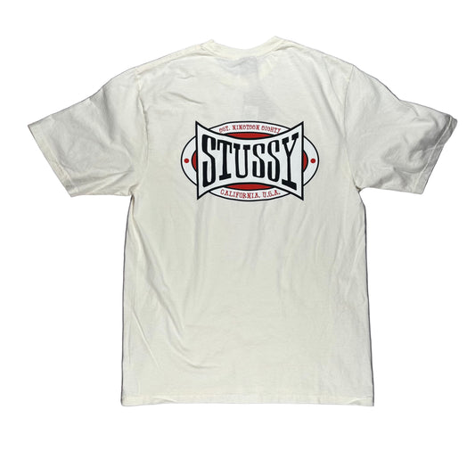 White t-shirt with Stussy logo on a white surface