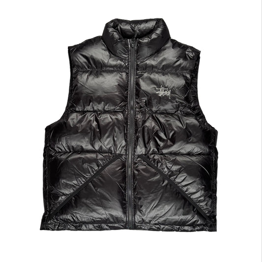 Black puffer vest with a brand logo on a white surface