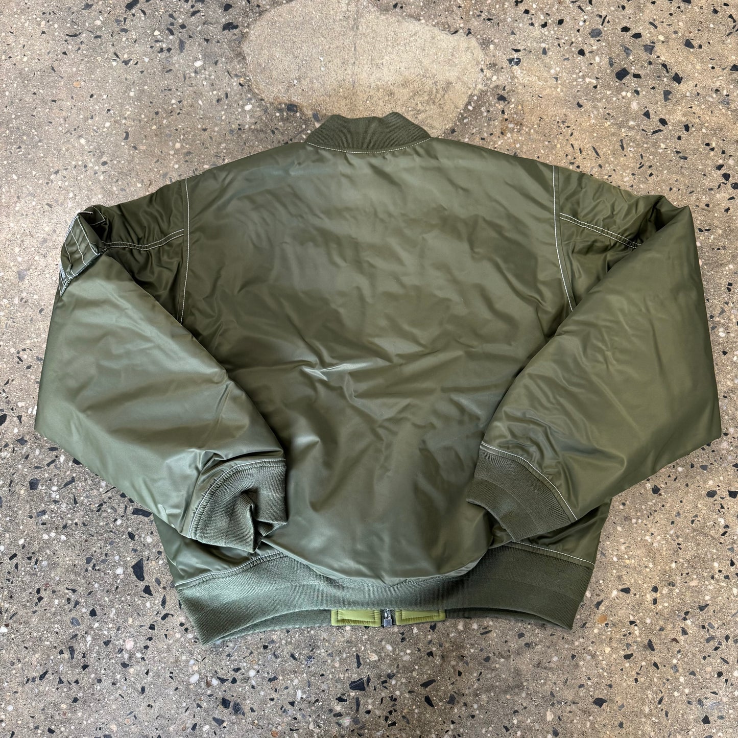 back view of bomber jacket, darker olive  jacket
