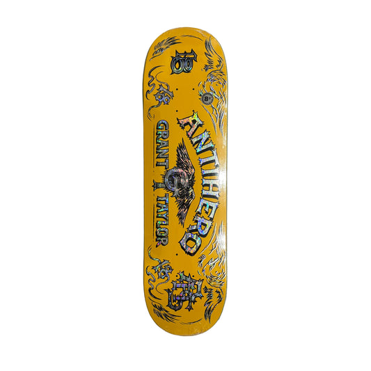 Yellow skateboard deck with black graphics on a white surface