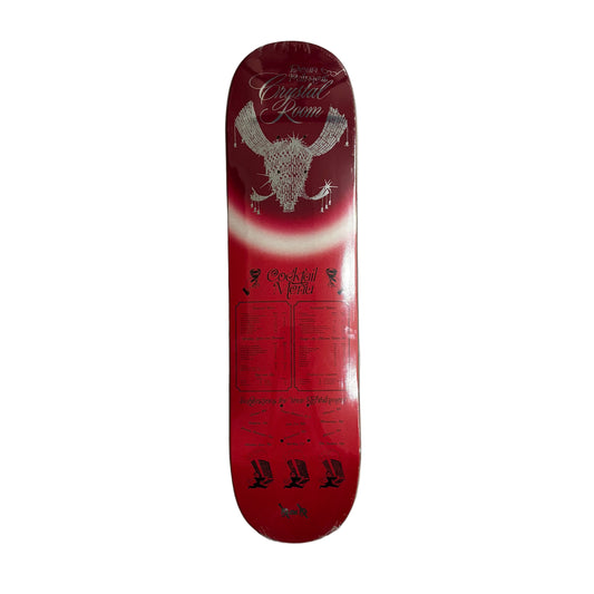 Red skateboard deck with white and black designs on a white surface