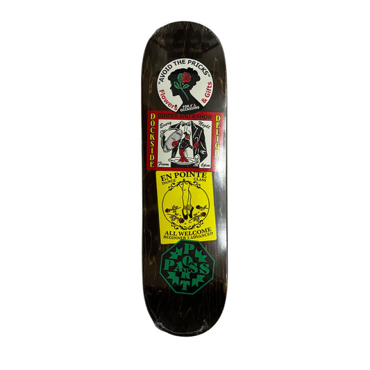 Skateboard deck with multiple sticker graphics on a white surface