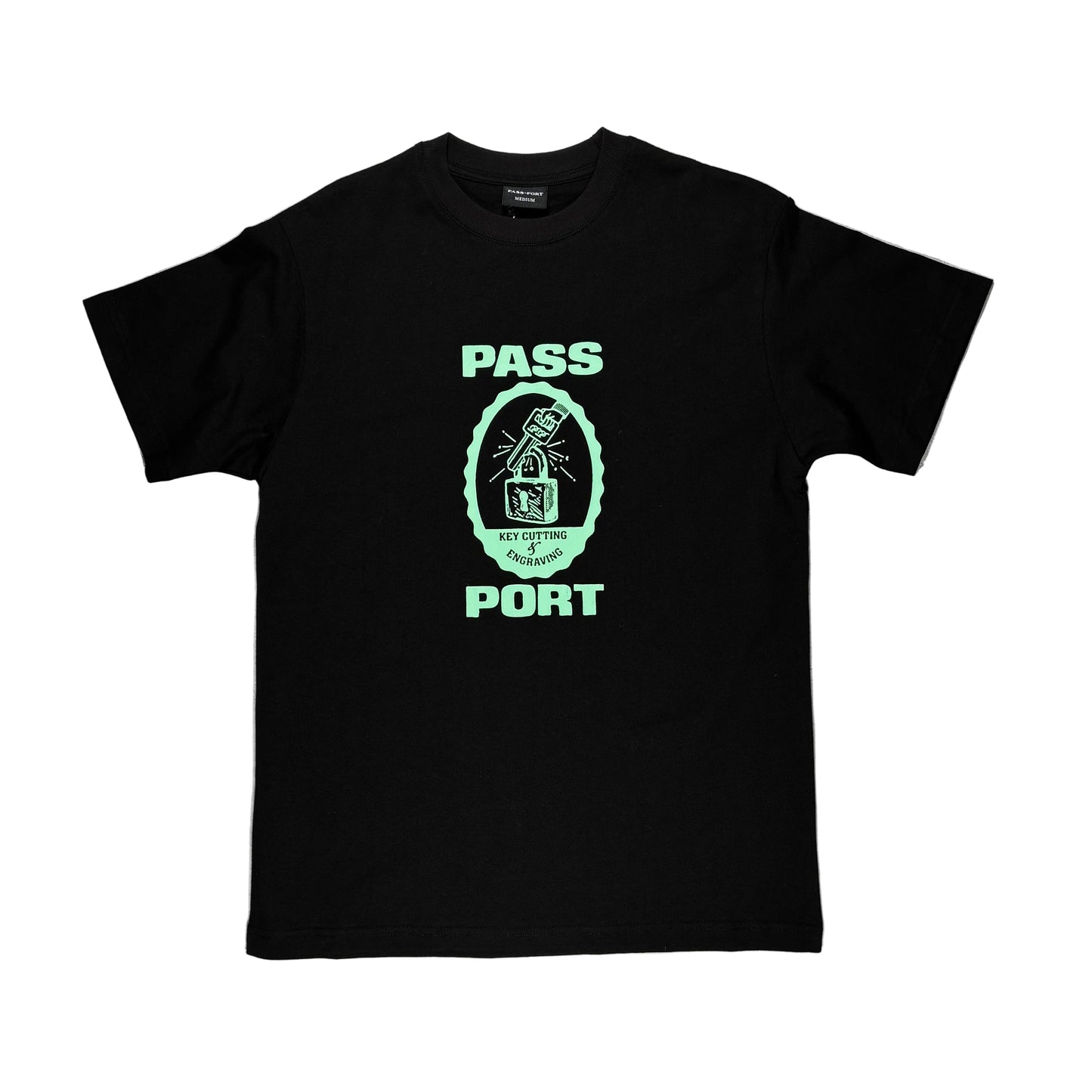 Black t-shirt with green graphic and text on a white surface