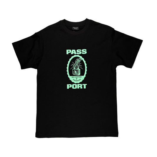Black t-shirt with green graphic and text on a white surface