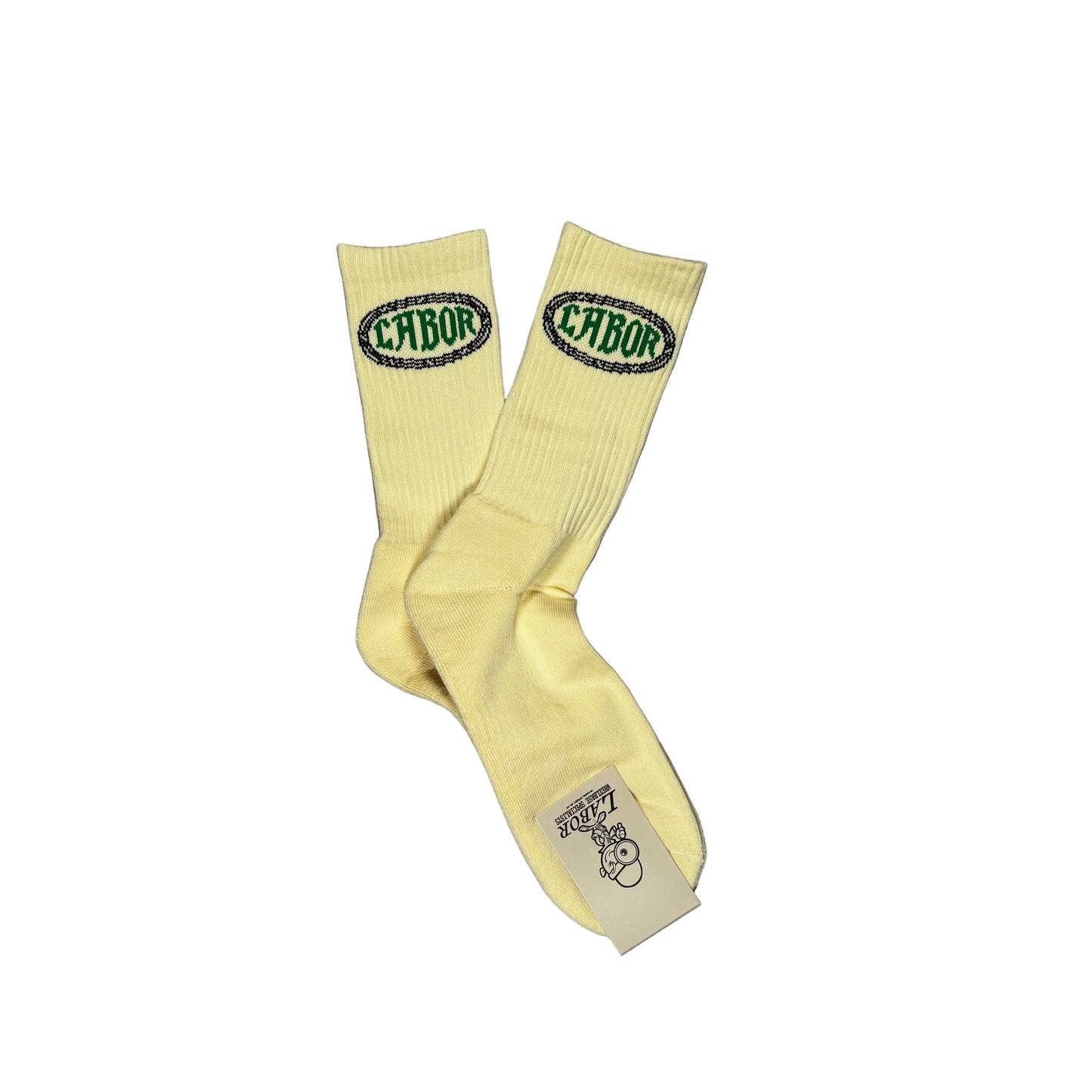 Pair of cream socks with green logo on a gray textured background