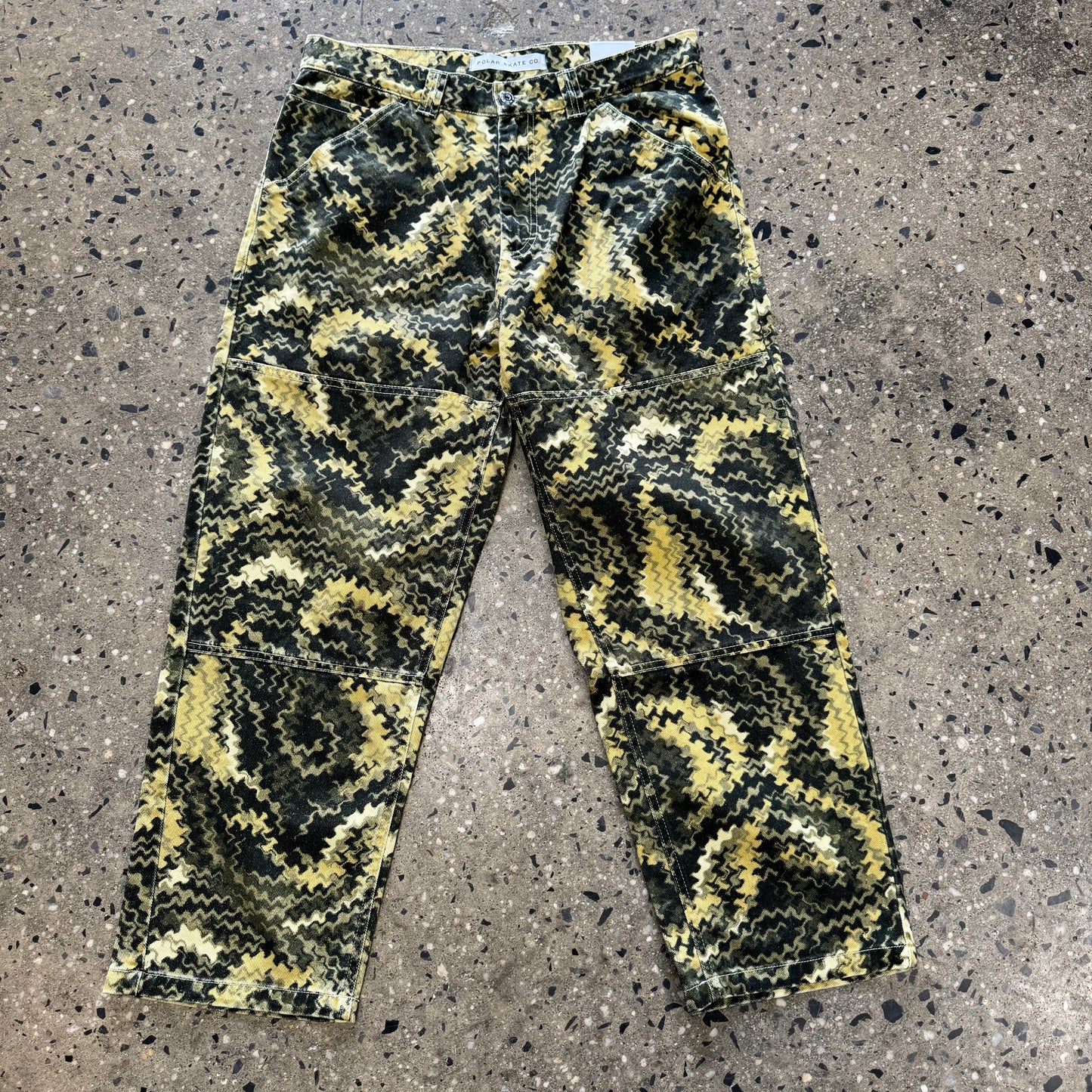 yellow and black abstract design on work pants