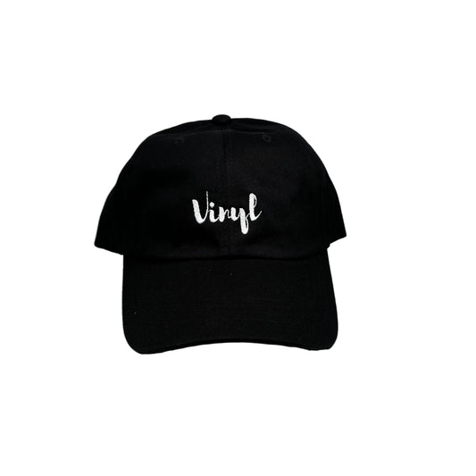 Black cap with 'vinyl' text on a white surface against a white background