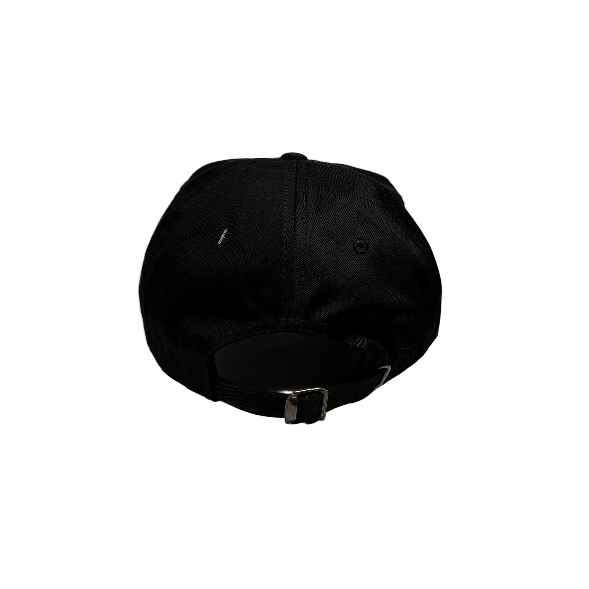 Black cap on a white pedestal against a white wall