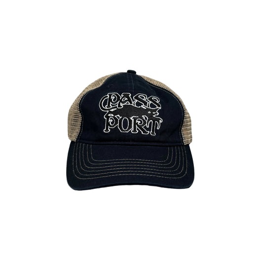 navy and beige cap with text on a white  wall