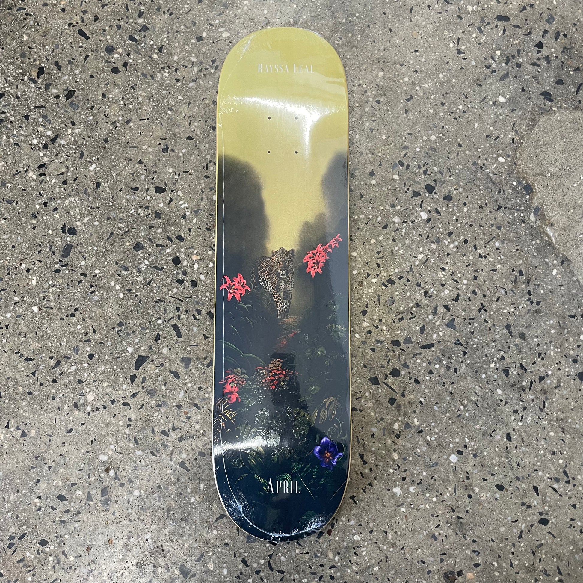 cheetah and multicolored flowers on yellow and black skate deck