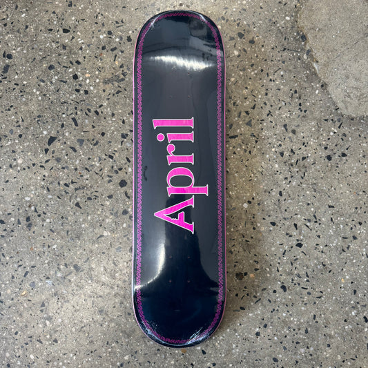 pink April logo on black skate deck
