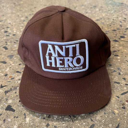 front view, white and brown anti hero skateboards stacked logo