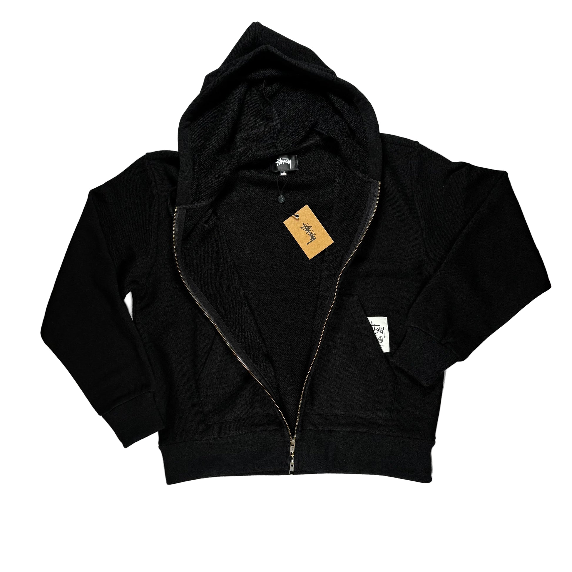 unzipped Black hoodie with a tag on a white surface