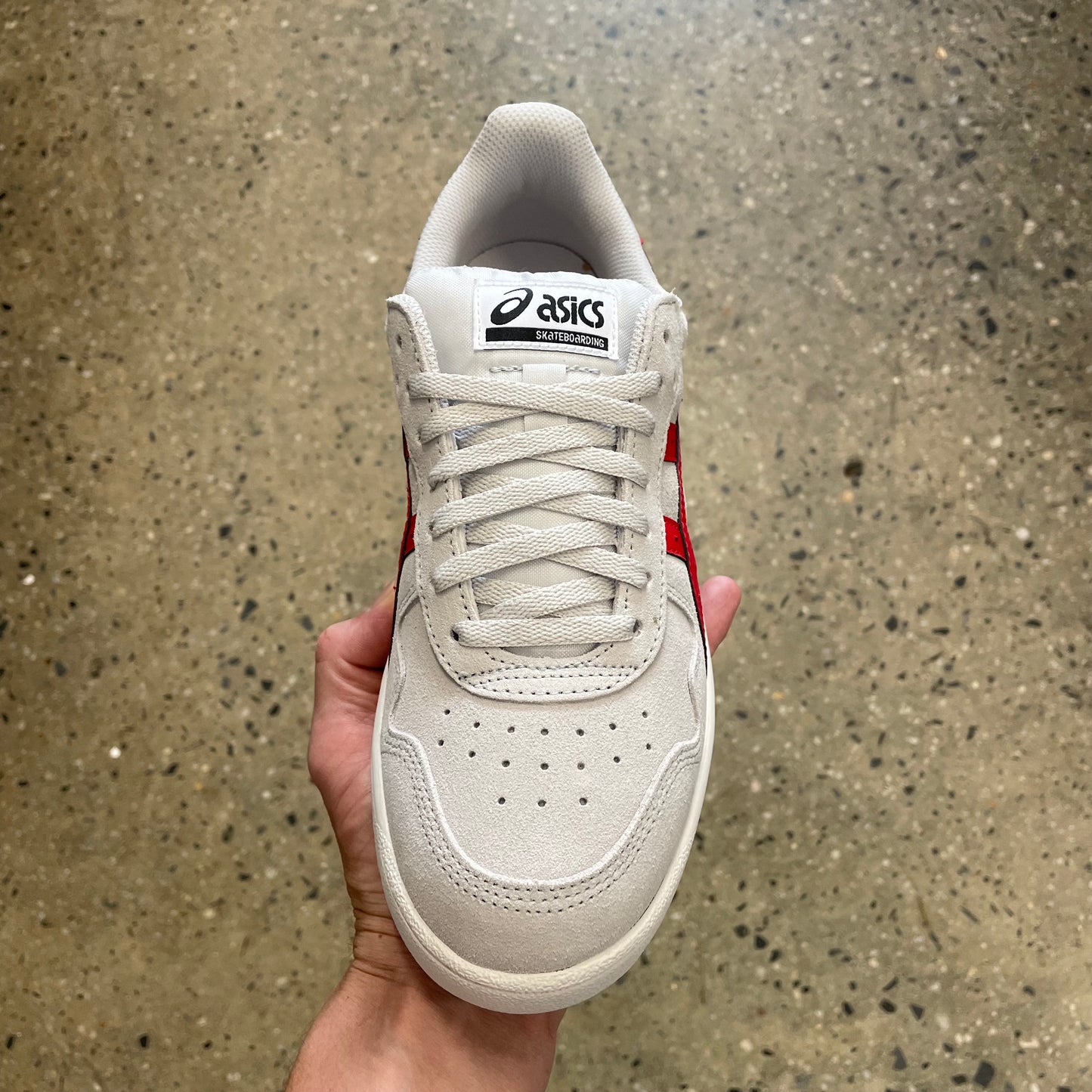 top down view of white and red suede skate sneaker