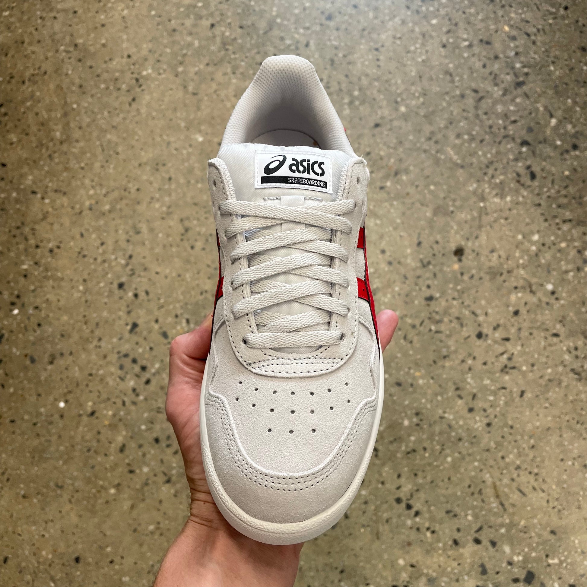 top down view of white and red suede skate sneaker