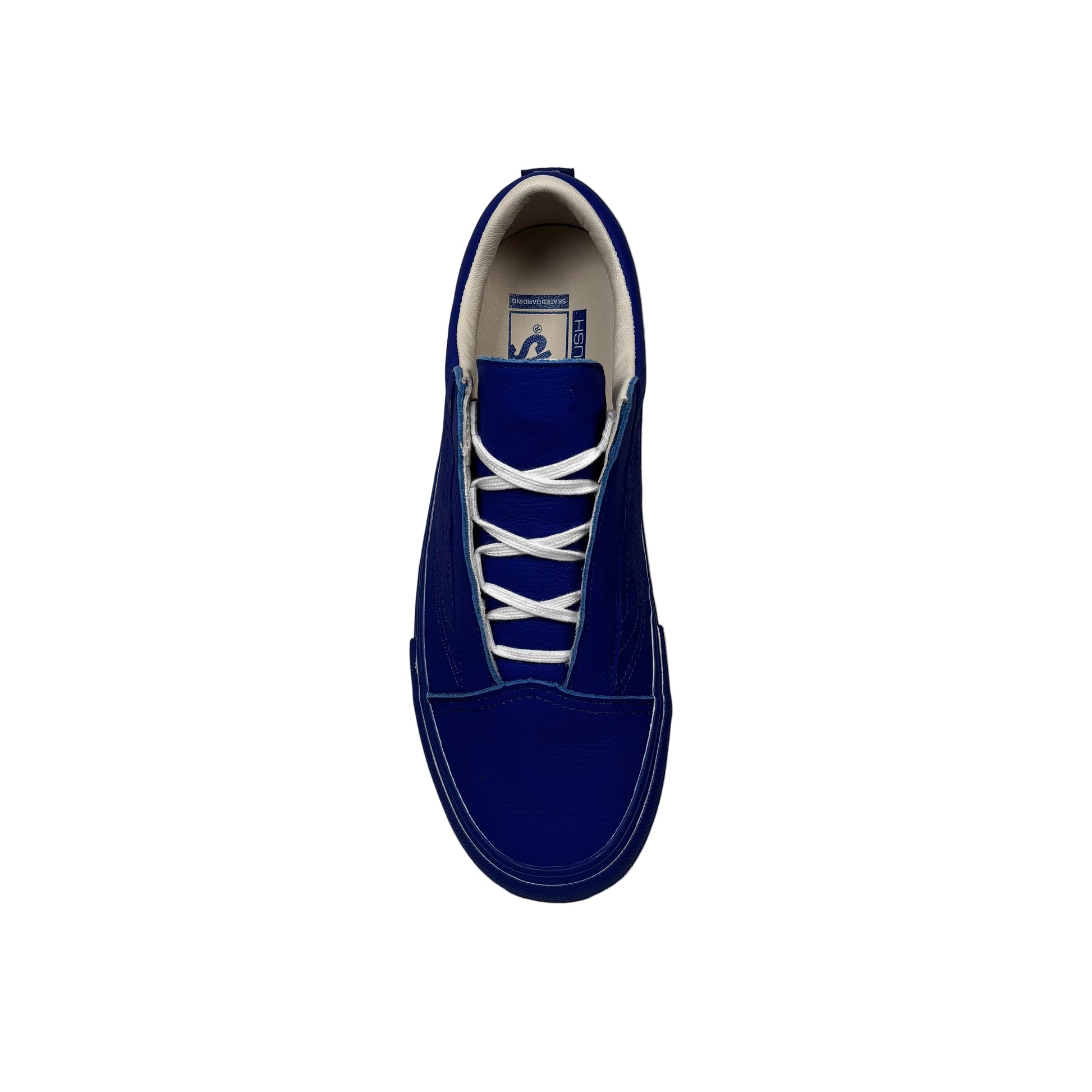 Blue sneaker with white laces on a white background