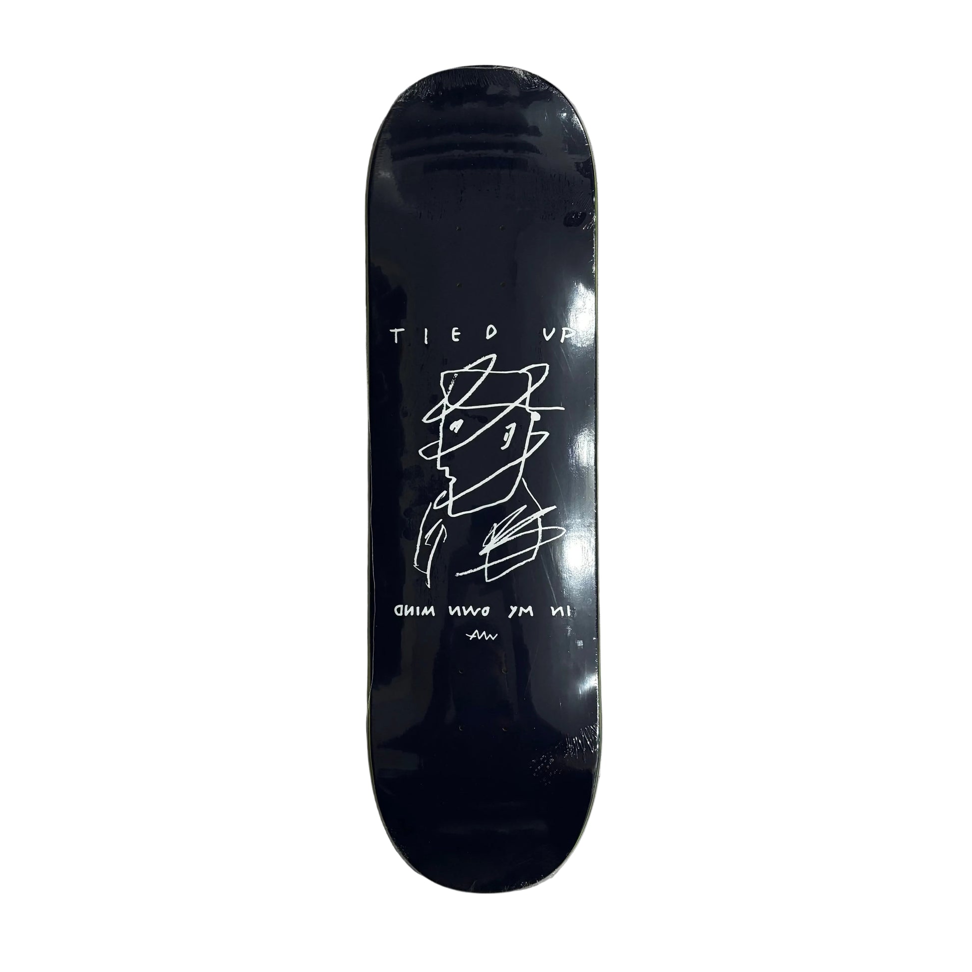 Black skateboard deck with white graphics on a white surface