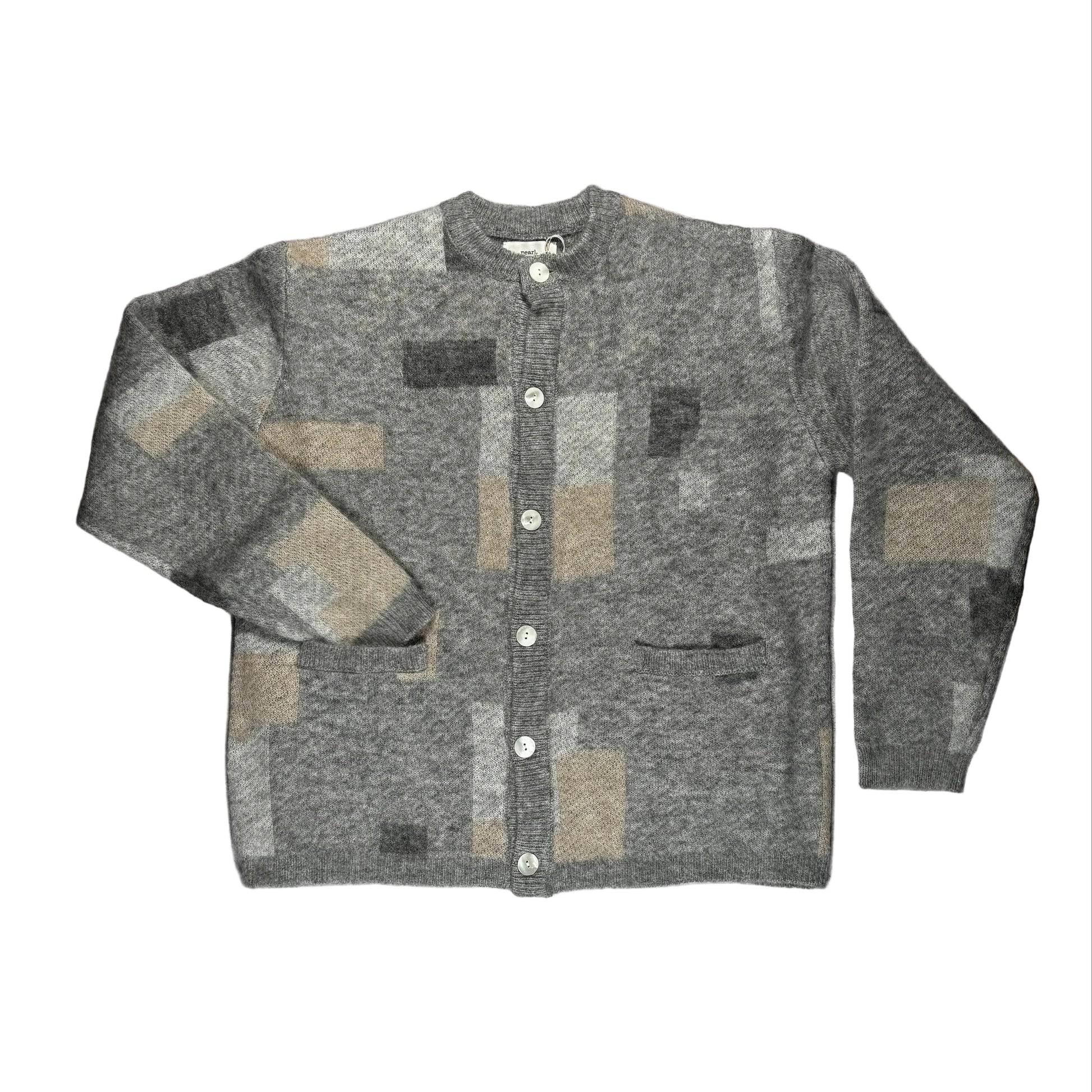 Gray patchwork cardigan on a white surface