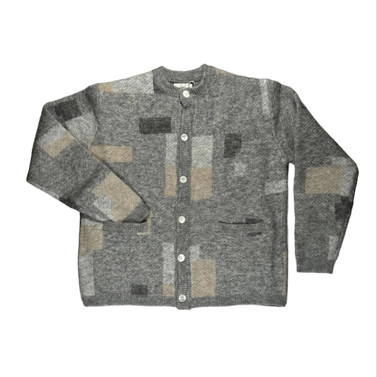 Gray patchwork cardigan on a white surface