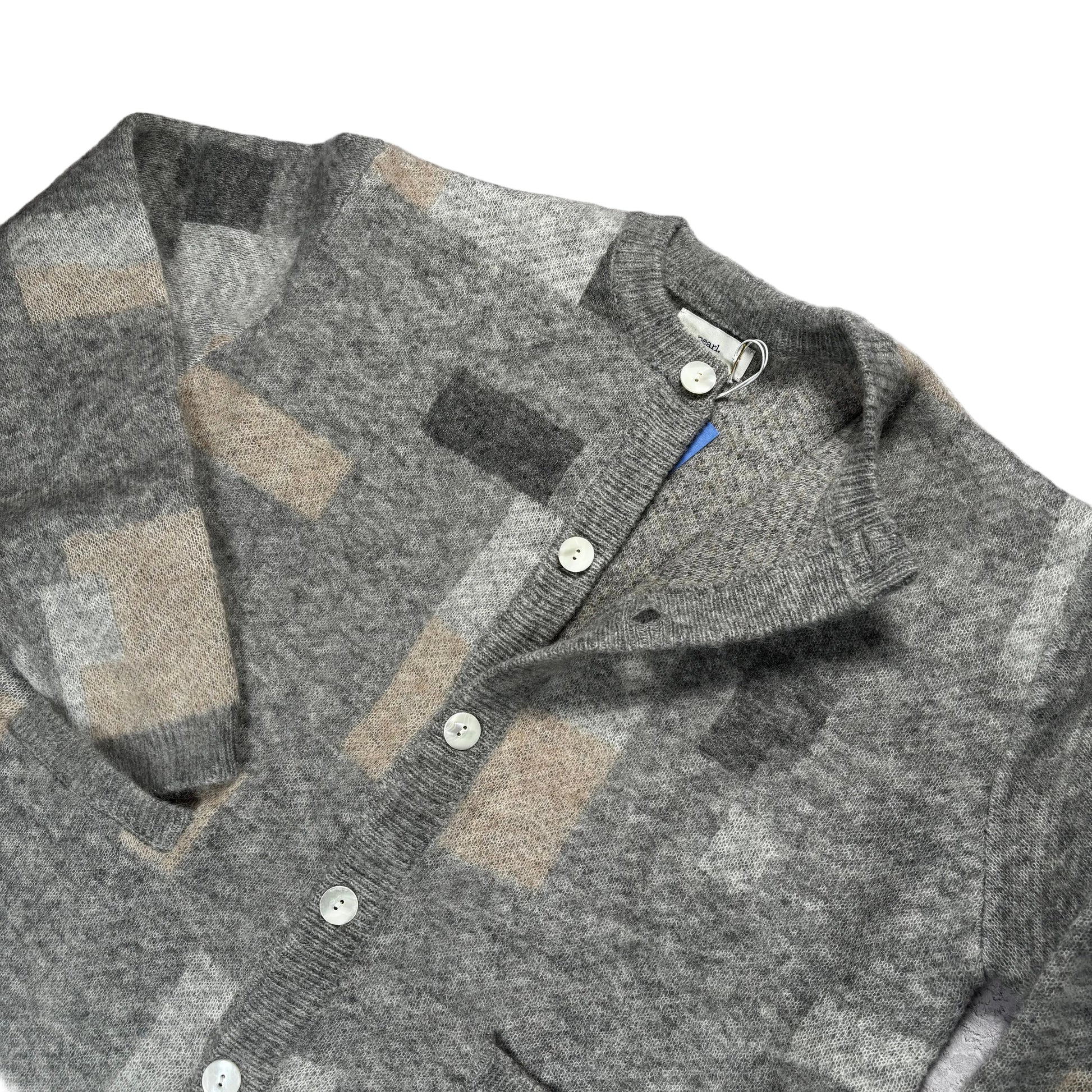 Gray checkered sweater on a white surface