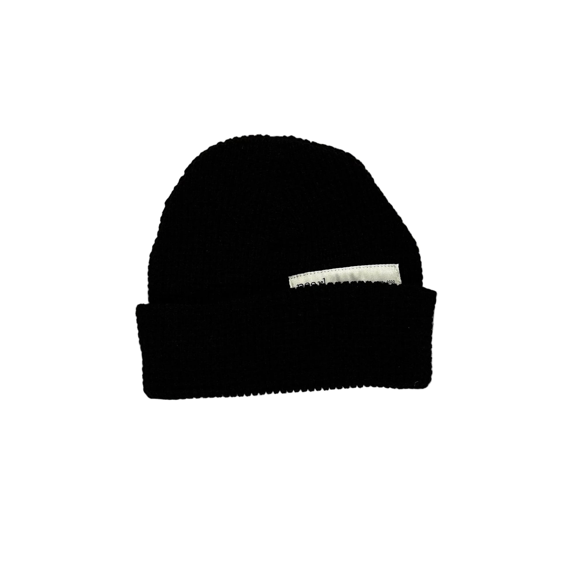 Black beanie on a white surface