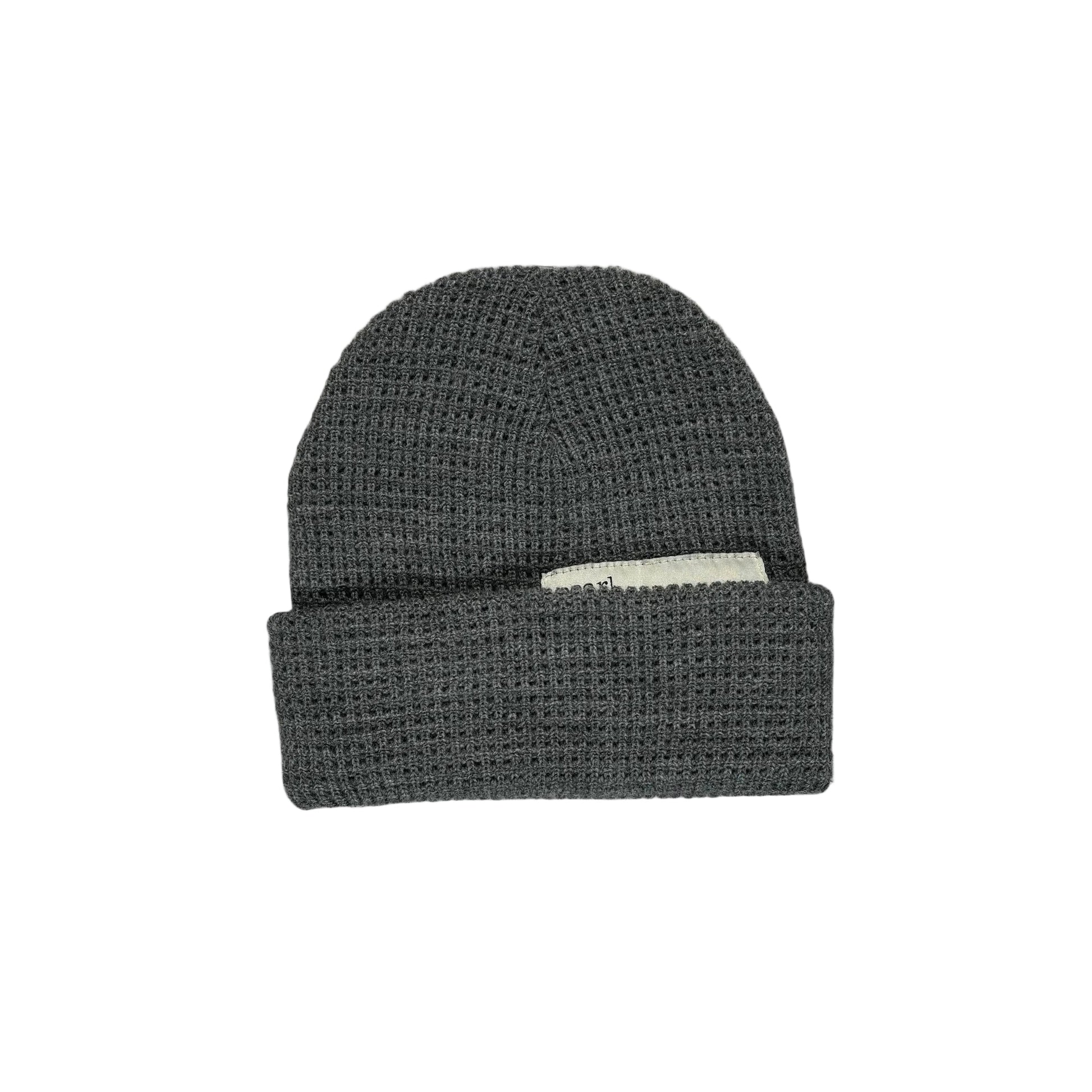 Dark gray knit beanie on a white surface