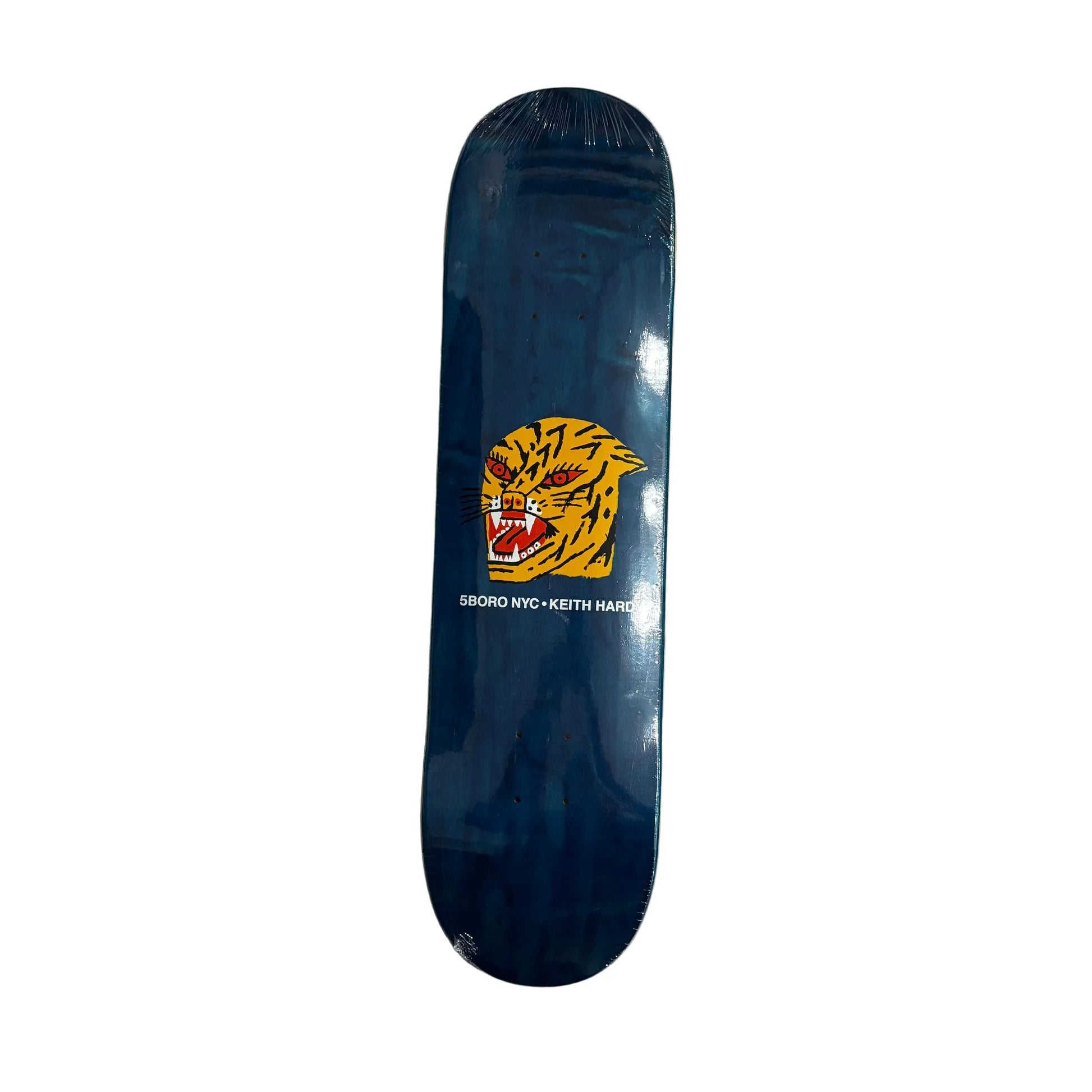 Blue skateboard deck with a yellow tiger logo on a white surface