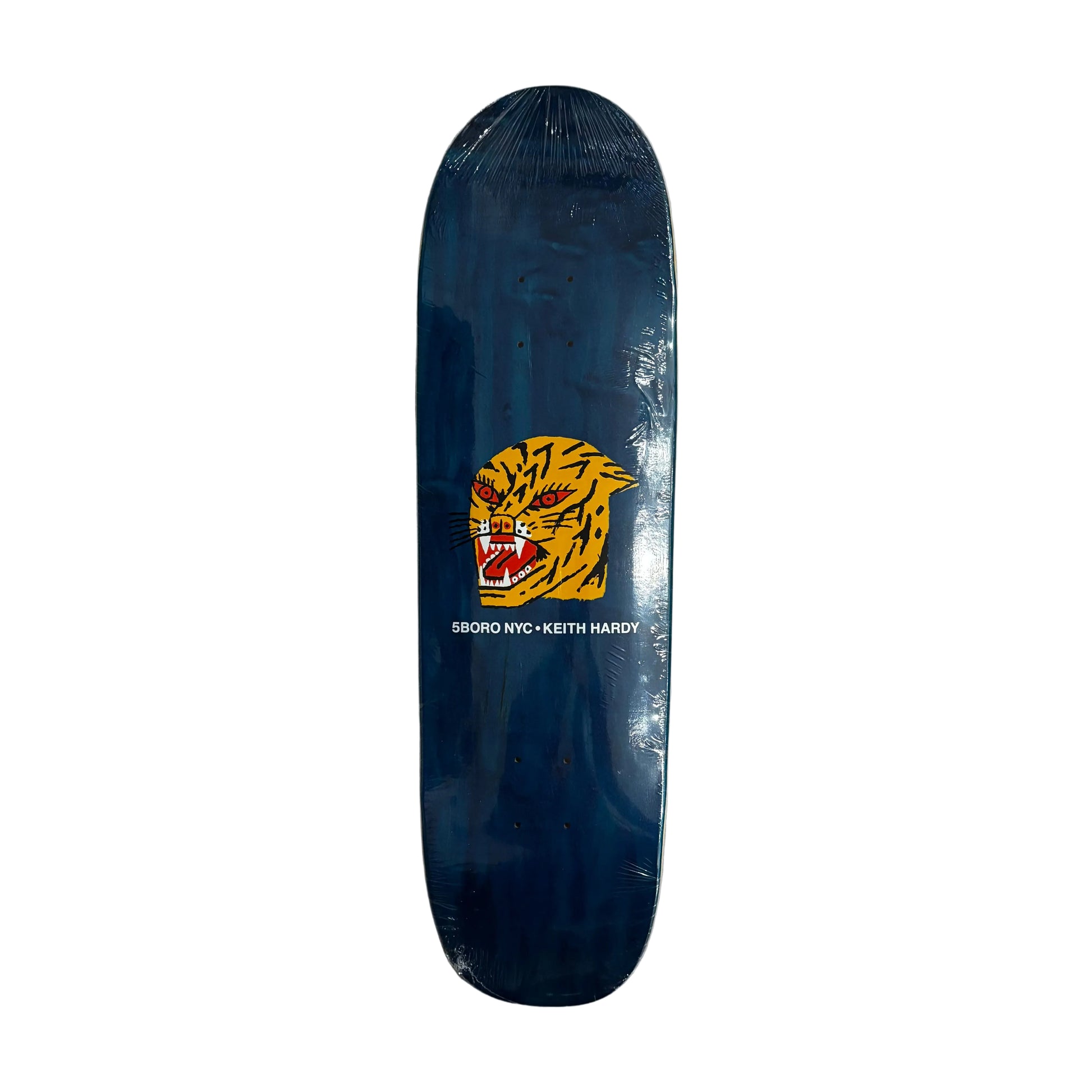 shaped Skateboard deck with a tiger logo on a white surface