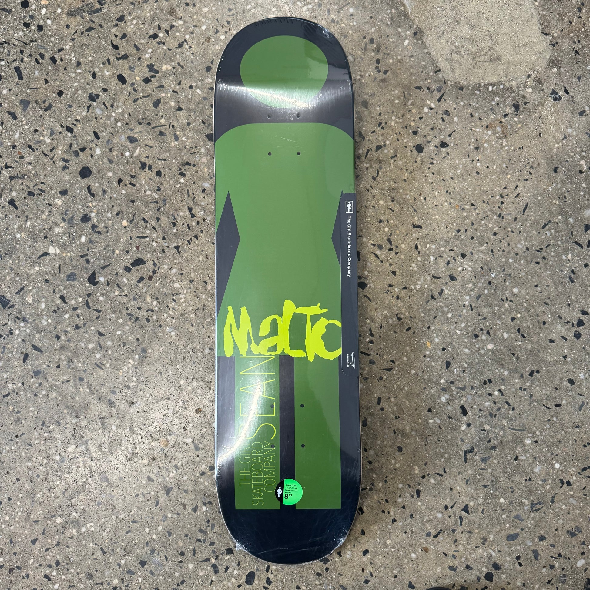 green girl logo on black skate deck with yellow writing