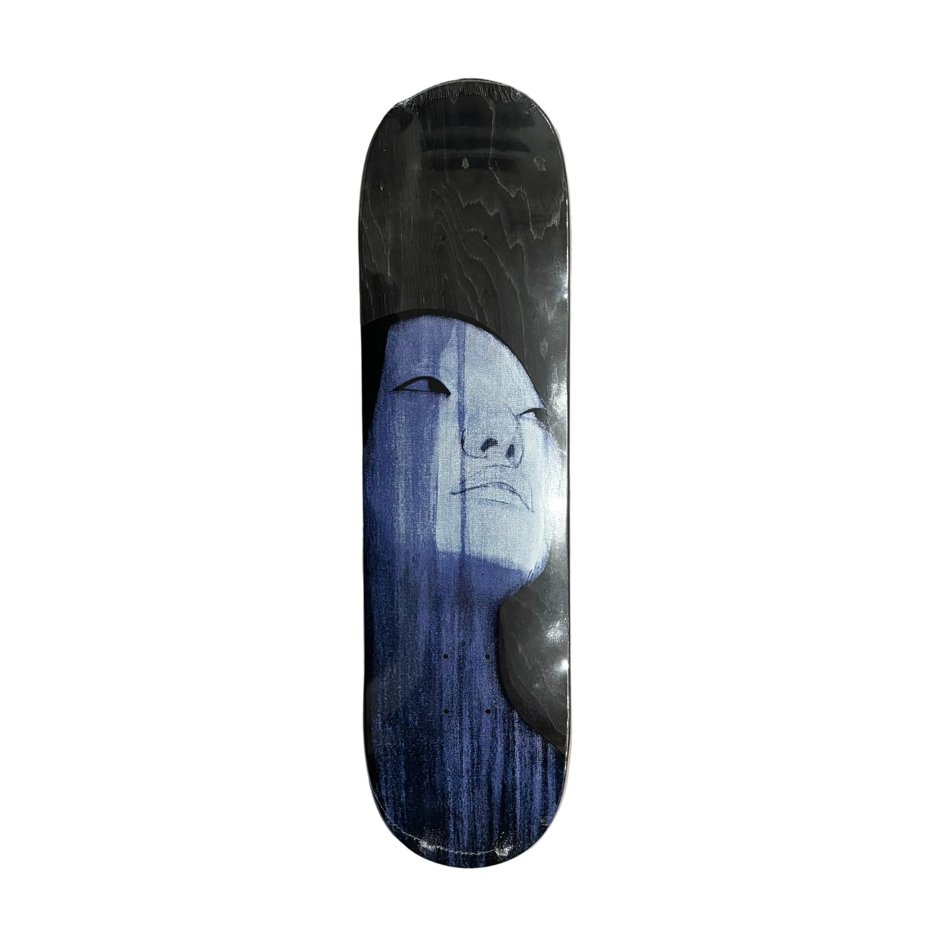 Skateboard deck with a face design on a white surface