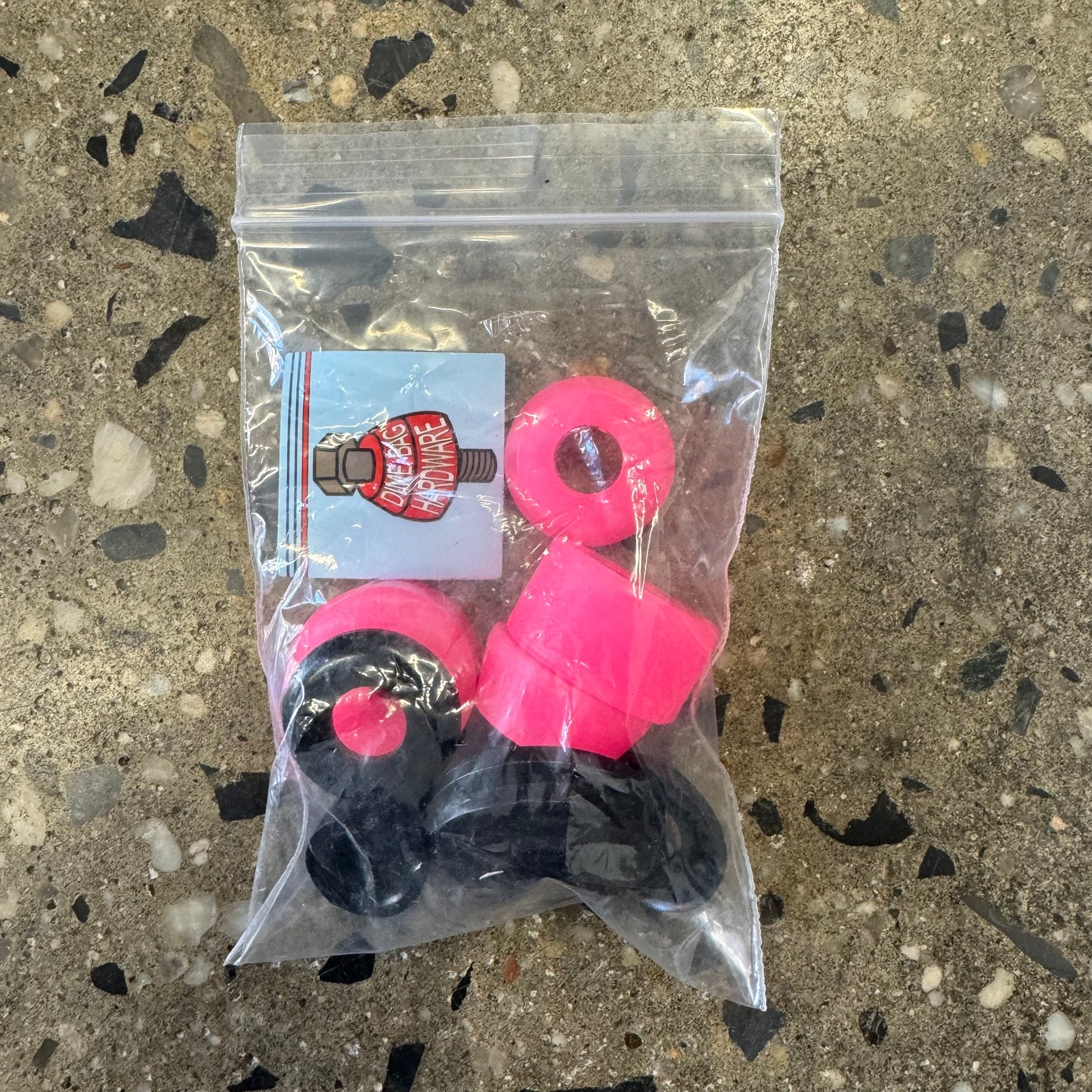 Pink urethane bushings, black washers, in small plastic bag