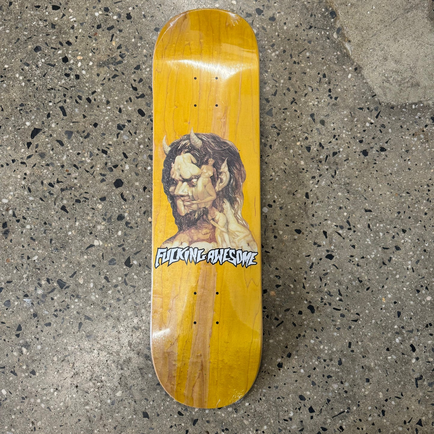 monster head on yellow skate deck