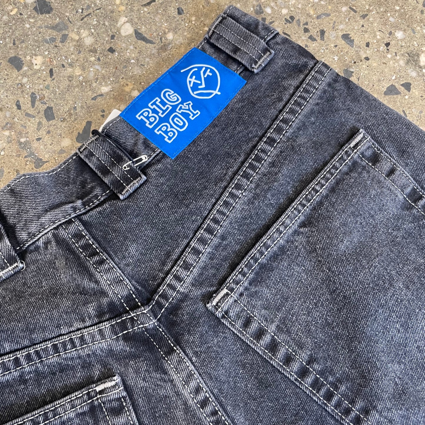 closeup of back pocket and blue patch logo
