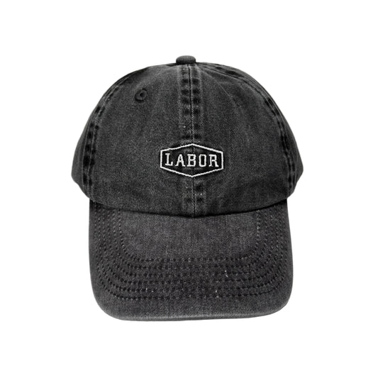 front view of black washed and distressed crest logo cap