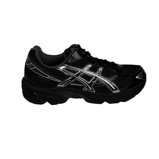 Black athletic shoe with white logo on a gray background