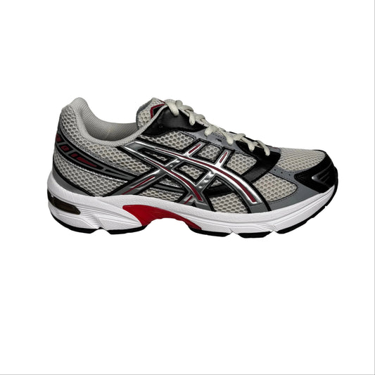 Gray and black running shoe with red accents on a white background