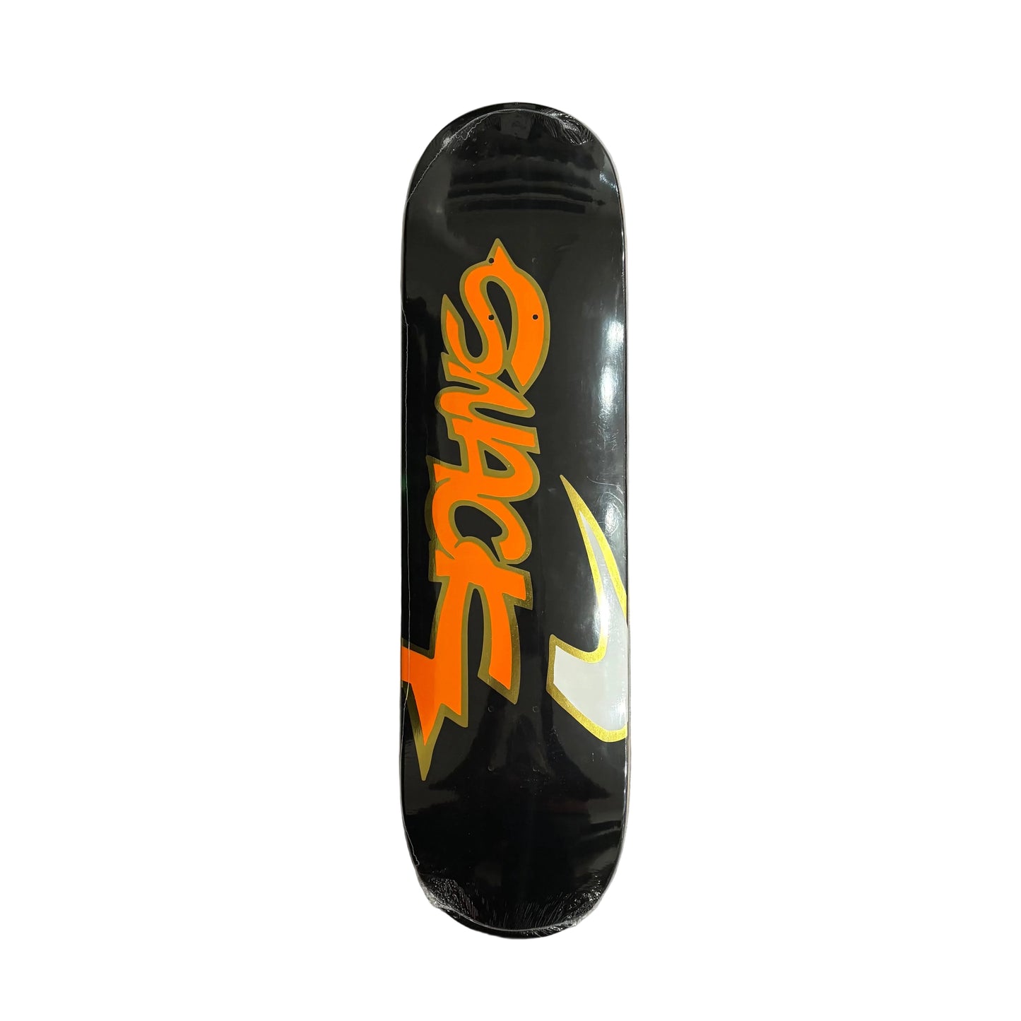 Black skateboard deck with orange and white graphics on a white surface
