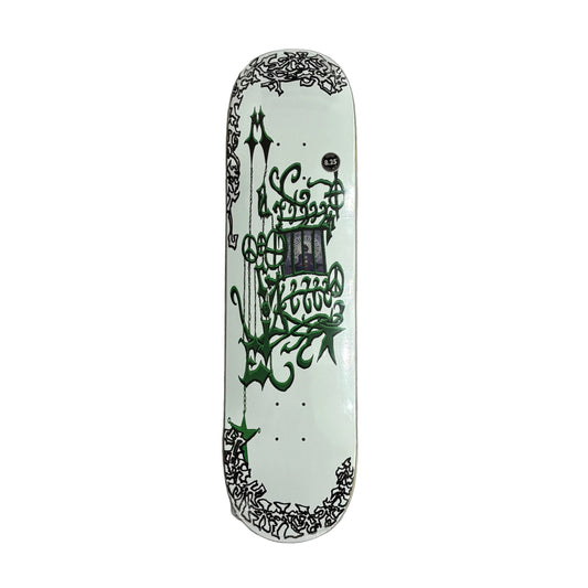 Skateboard deck with intricate green and black hand drawn style designs on a white surface