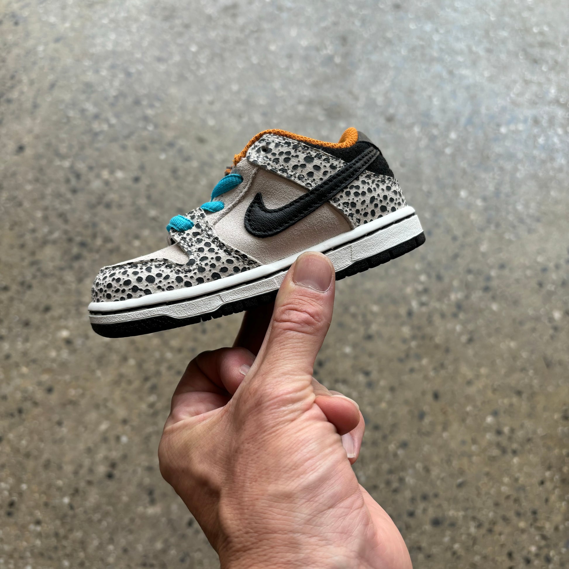 Side view of safari print toddler size nike SB dunk low