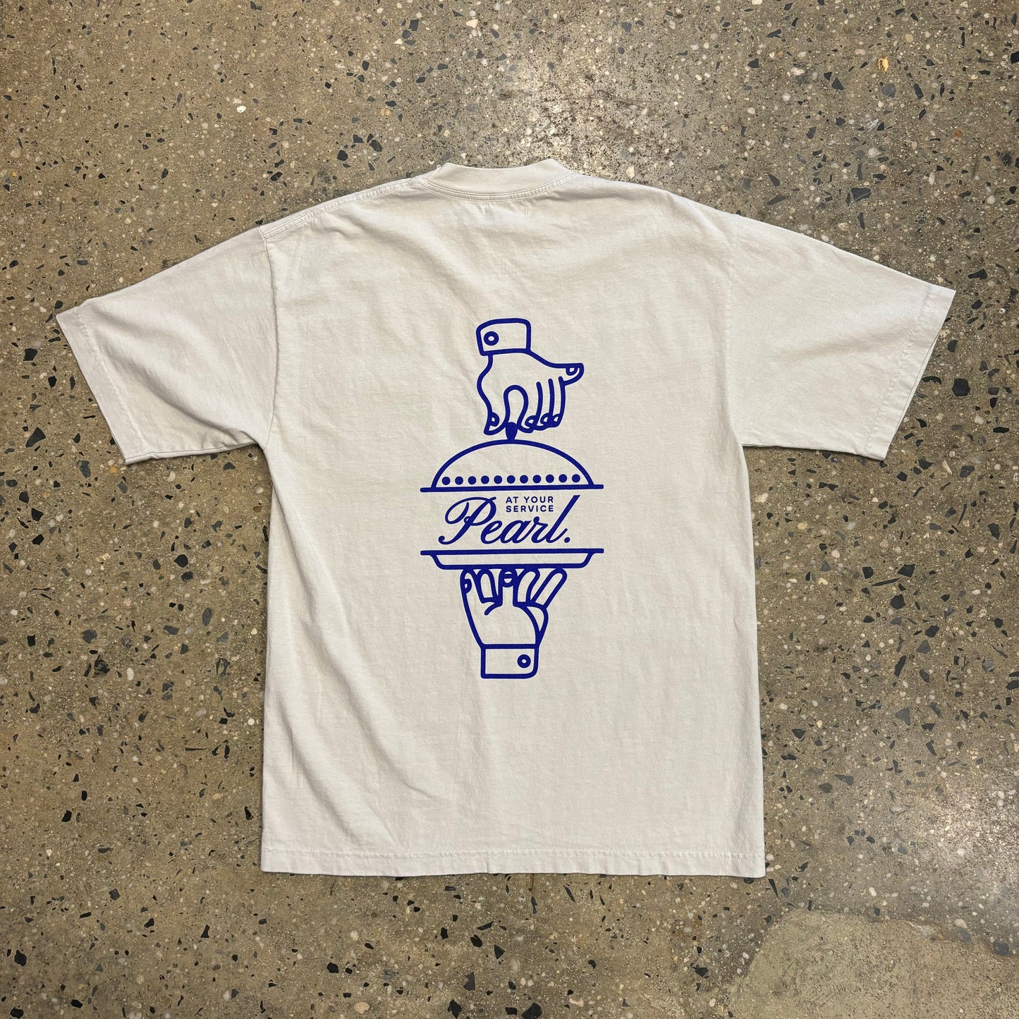 Rear view of t-shirt with hands opening a blue screenprinted serving dish