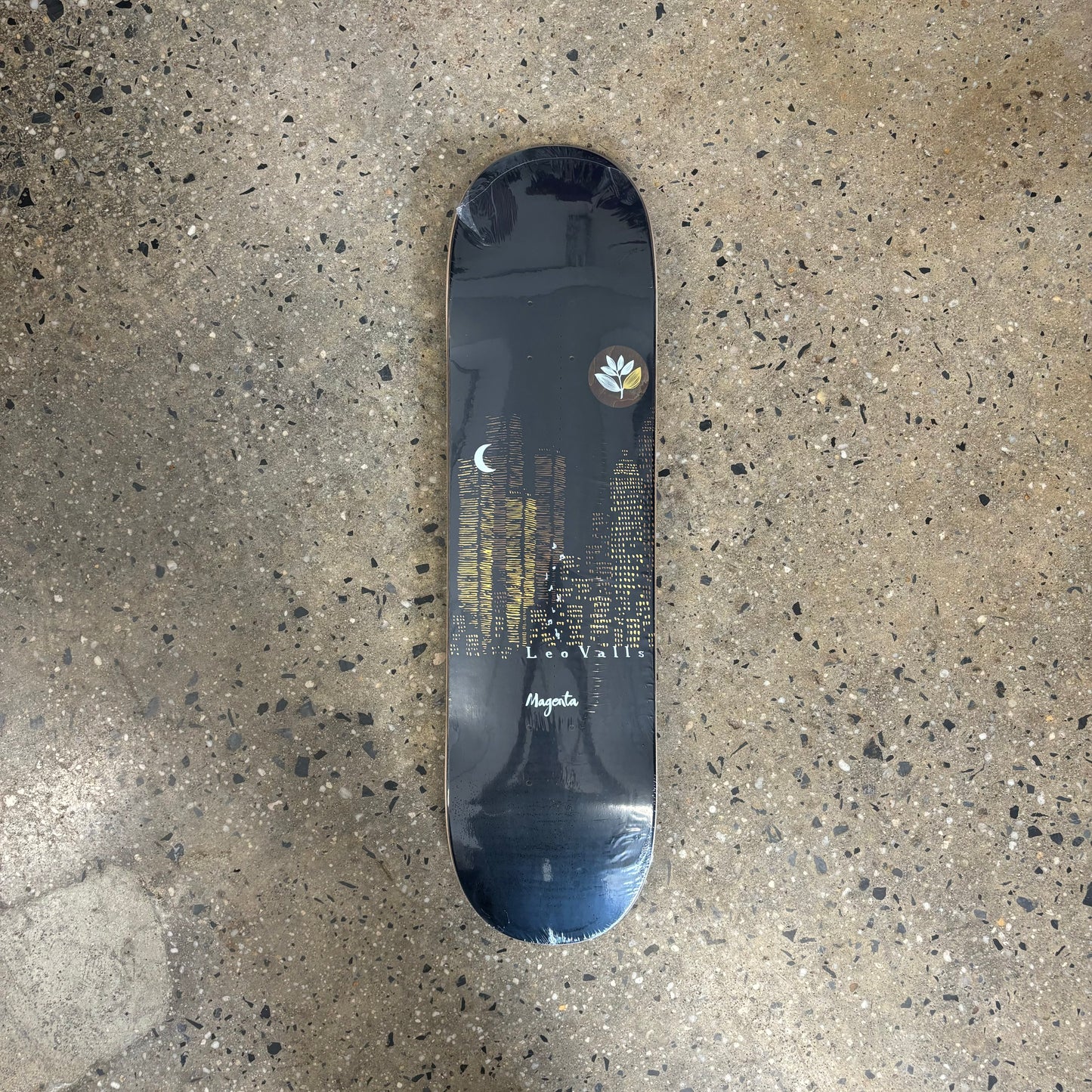 Navy blue background with skyscrapers in the background on skateboard deck