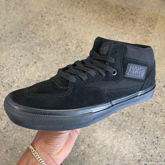 All black mid top skateboard shoe in suede and canvas, tonal black outsole