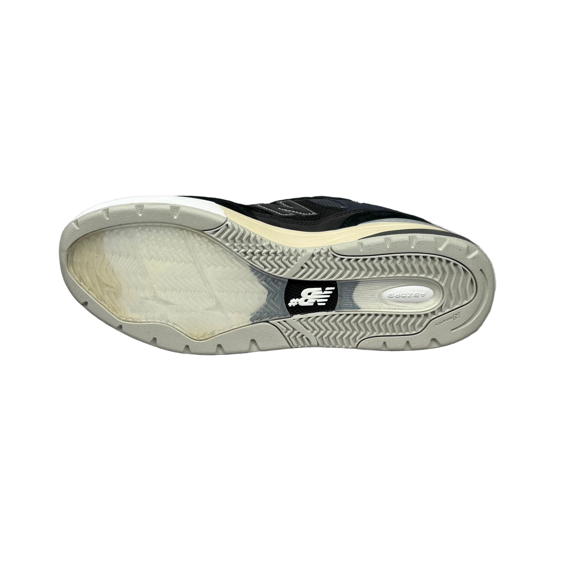 Black sneaker with white and clear sole on a white background