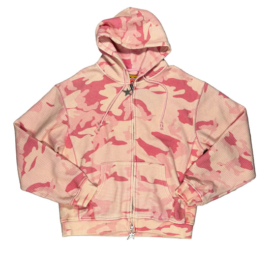 Pink camouflage hoodie on a gray surface