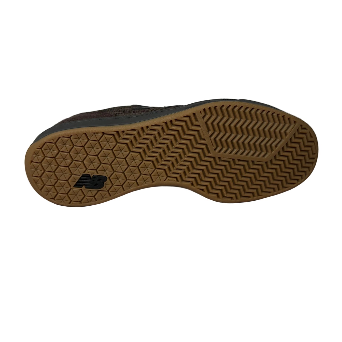 Sole of a black shoe with brown sole on a white surface